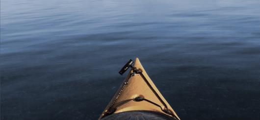 Book cover for "The Last Layer of the Ocean" a yellow kayak on a calm body of water